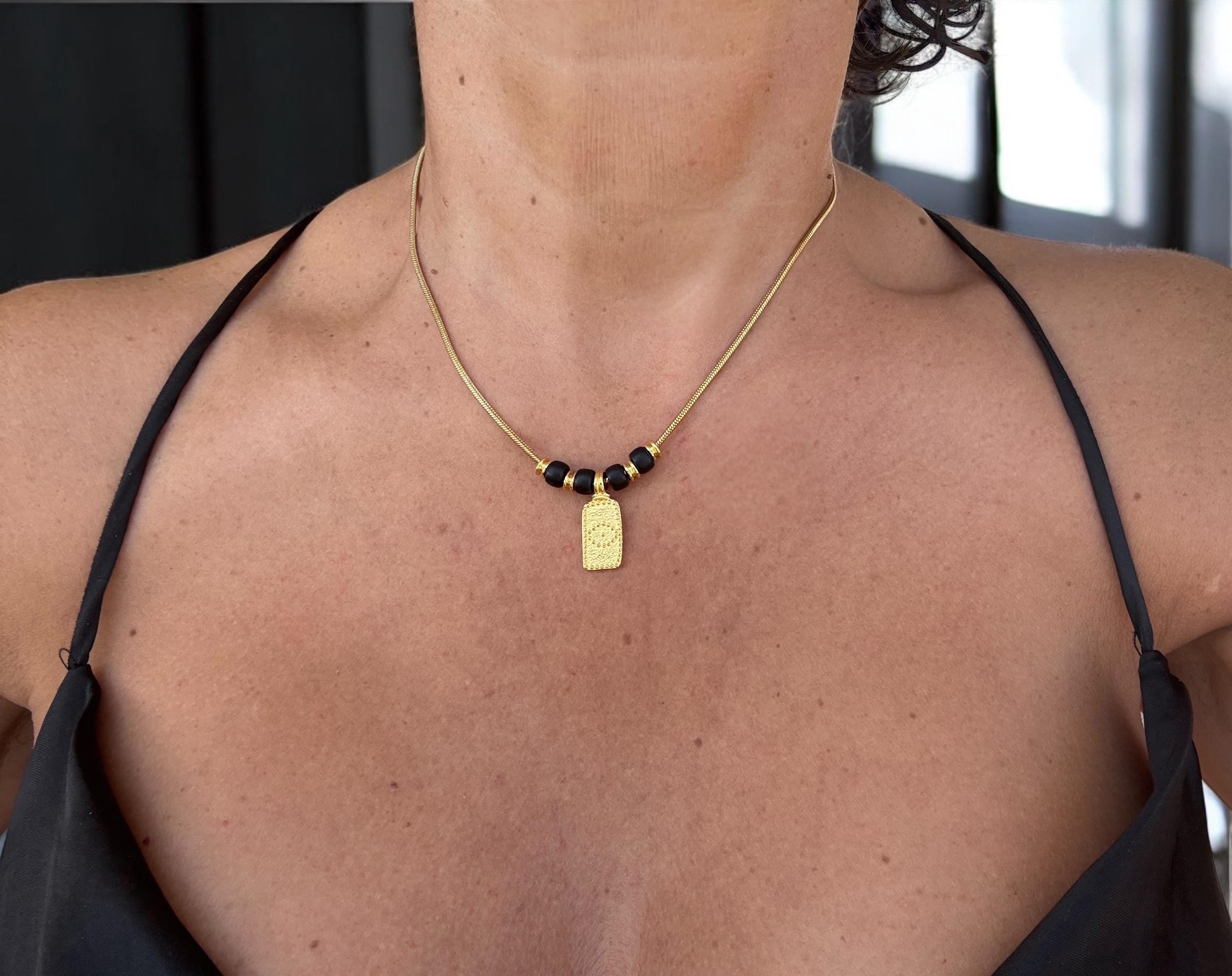 Dainty gold necklace with symbolic eye pendant and black crystals - delicate choker