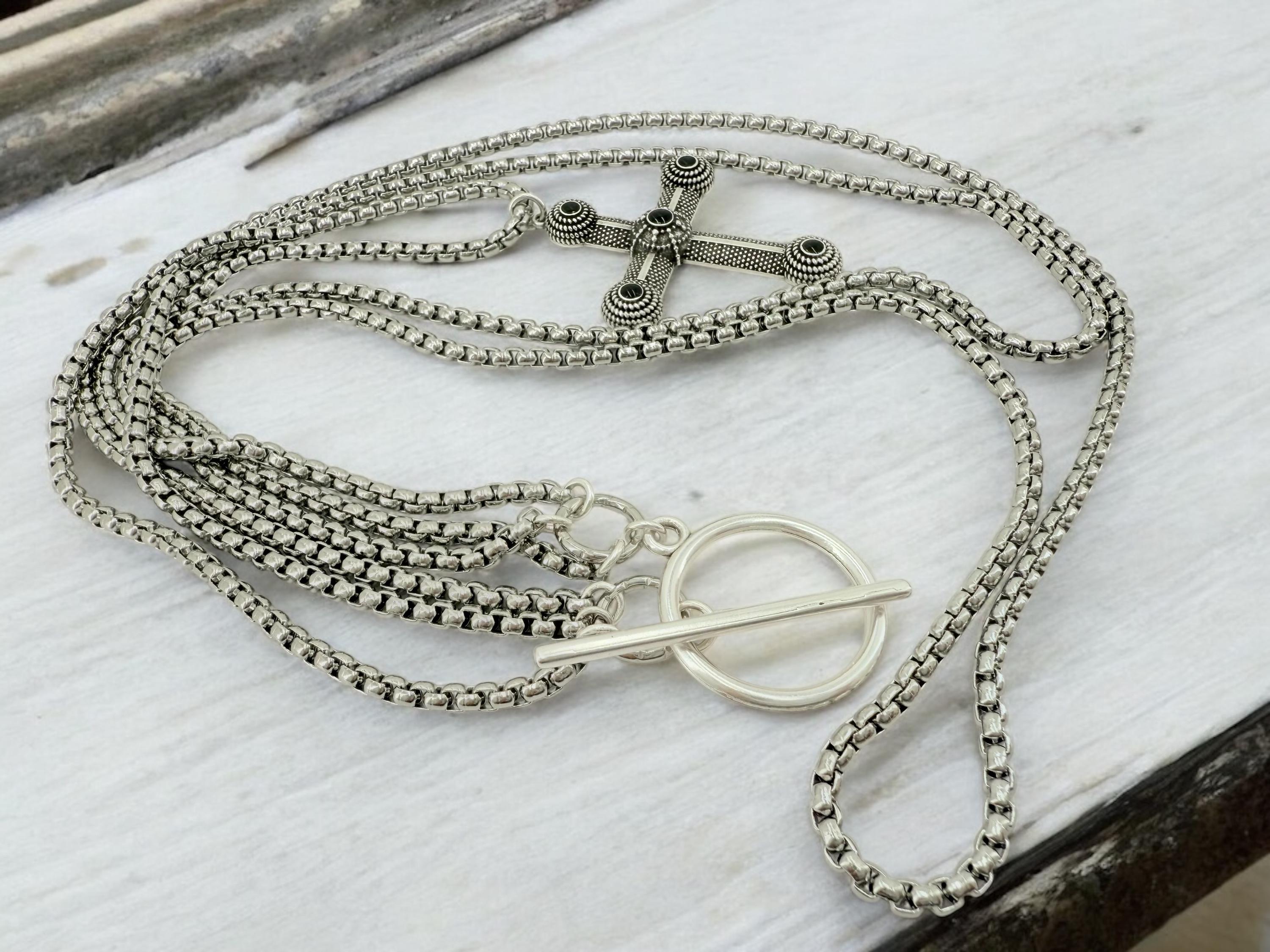 Long dark silver triple-chain necklace with black enamel cross pendant, bold layered choker