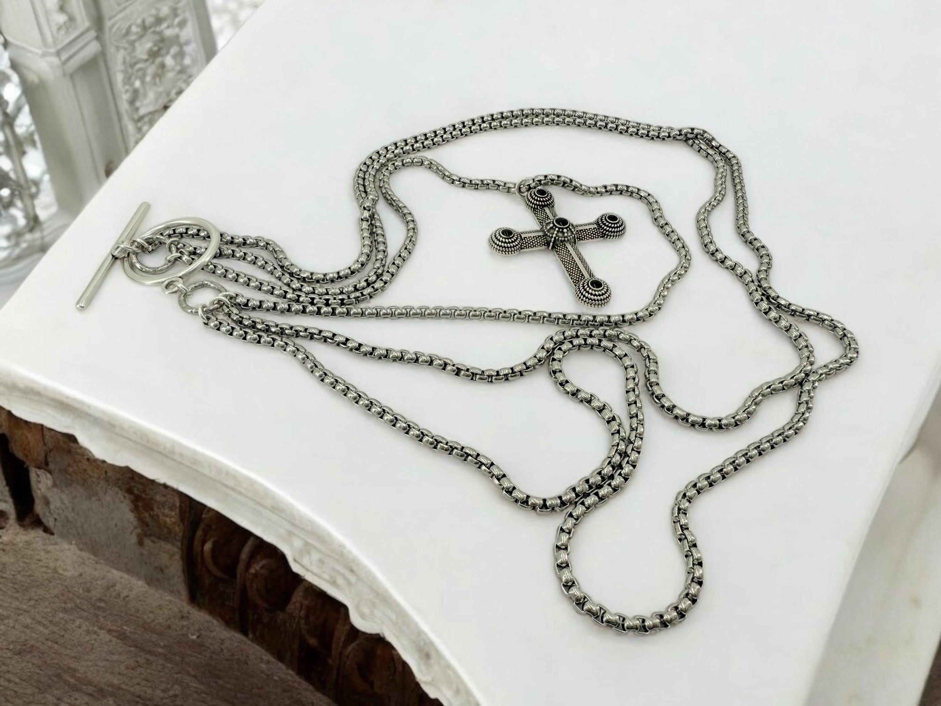 Long dark silver triple-chain necklace with black enamel cross pendant, bold layered choker