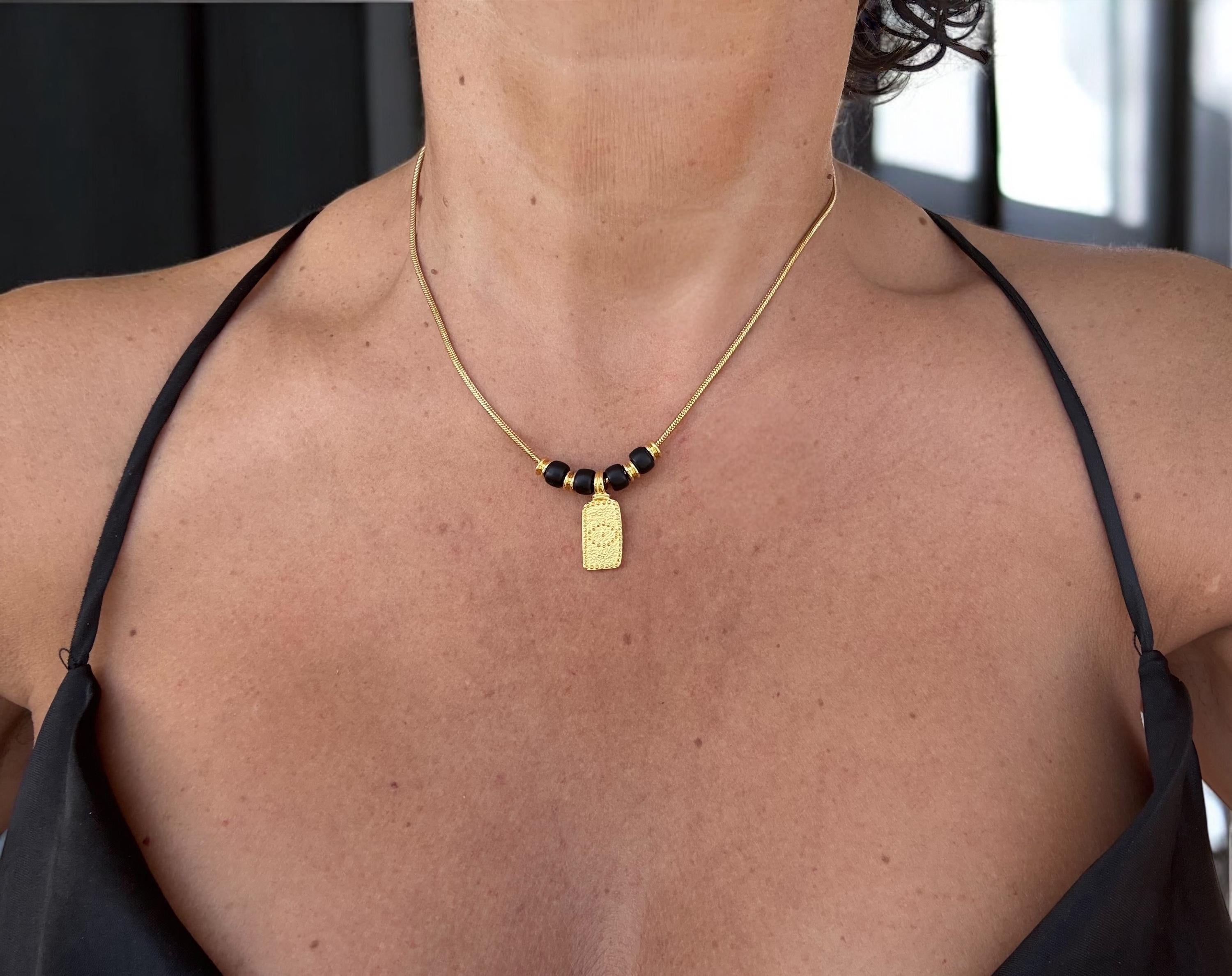 Dainty gold necklace with symbolic eye pendant and black crystals, delicate tribal choker