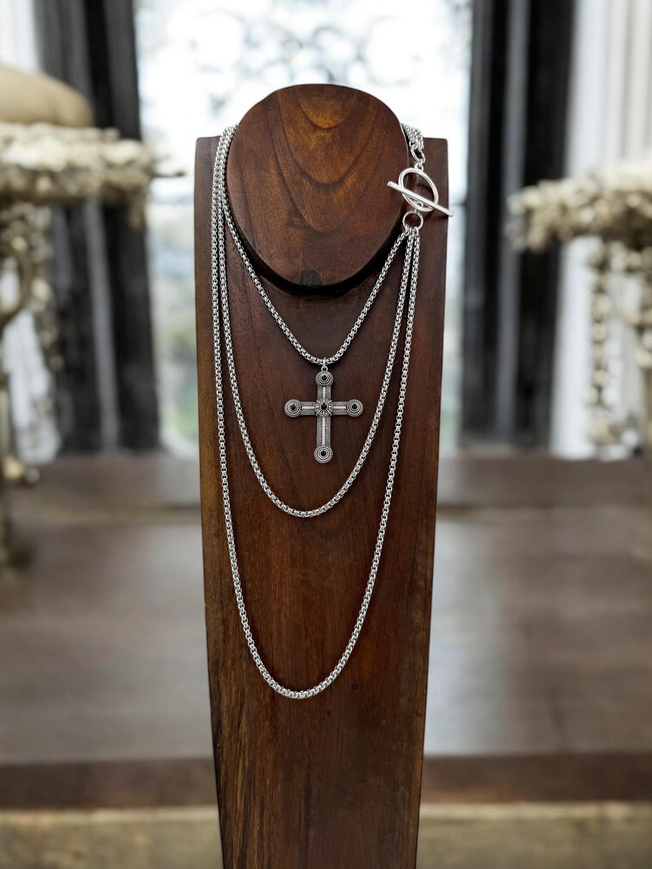 Long dark silver triple-chain necklace with black enamel cross pendant, bold layered choker