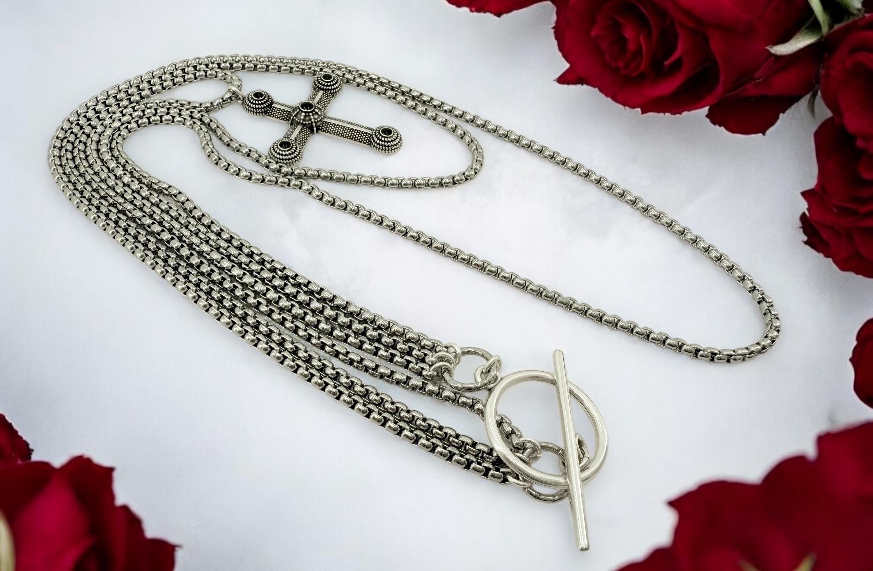 Long dark silver triple-chain necklace with black enamel cross pendant, bold layered choker